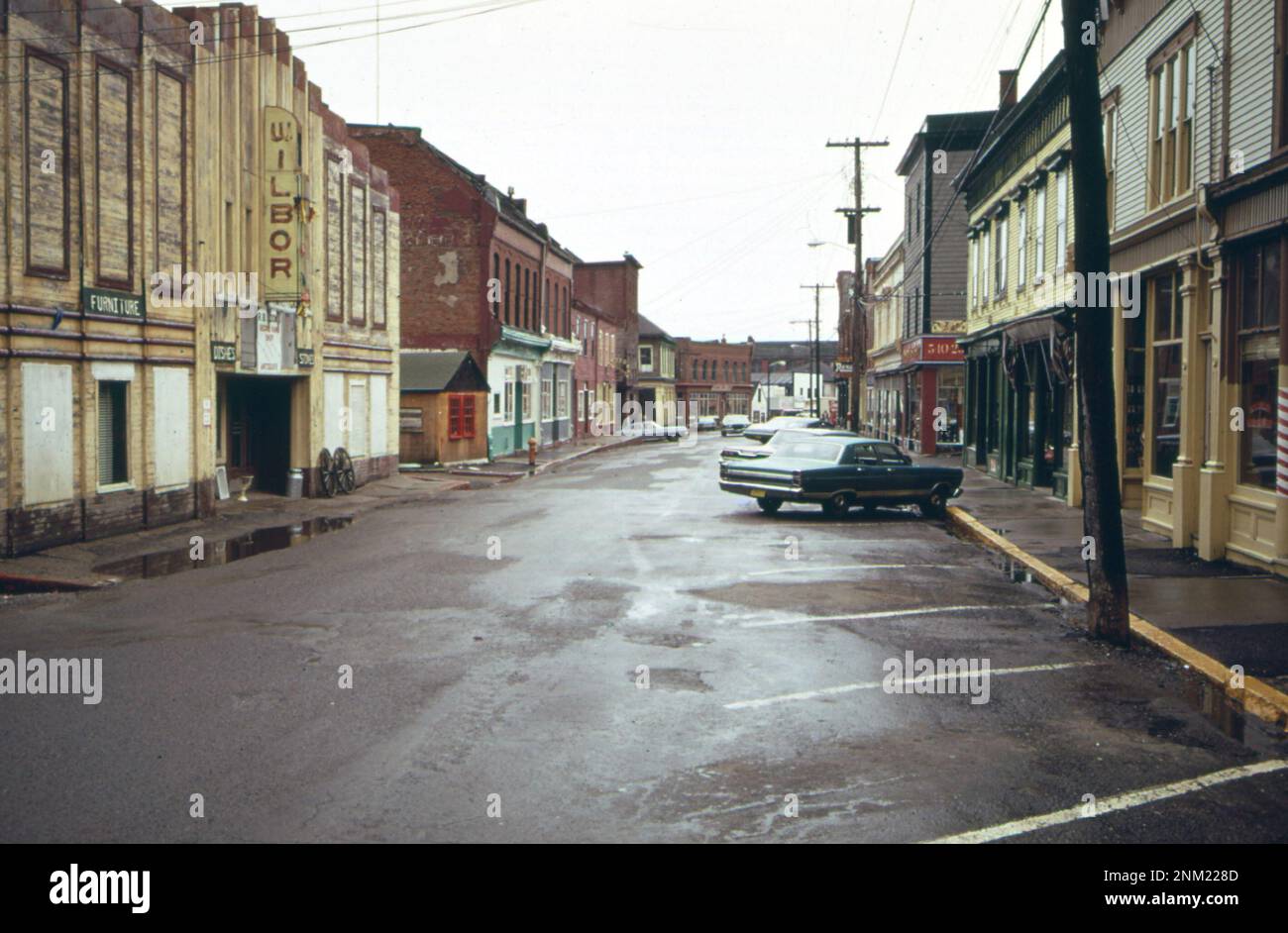 1970s United States One car parked on Main street of Eastport, Maine at midday ca. 1973 Stock