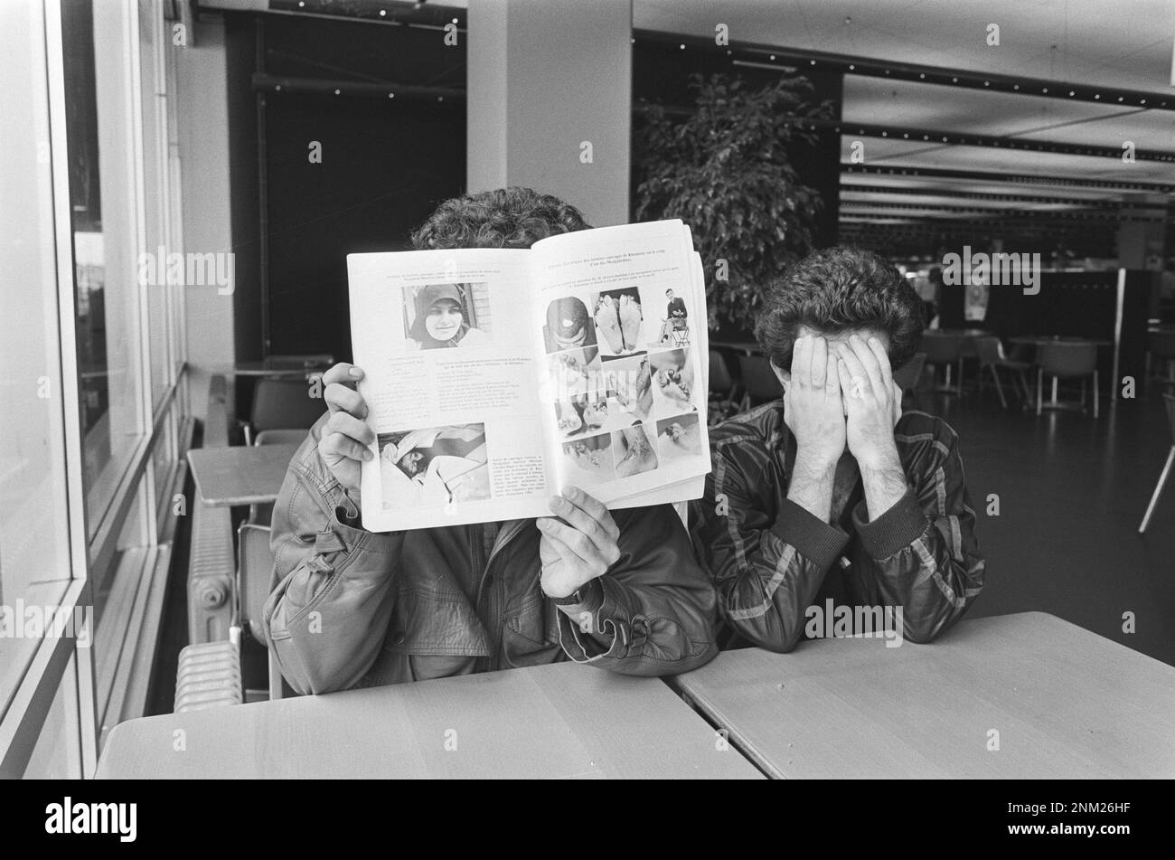 Iranian asylum seekers hiding their faces, must remain at Schiphol ca. 1985 Stock Photo