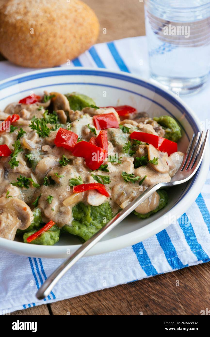 Spinach gnocchi with mushrooms and bell pepper Stock Photo