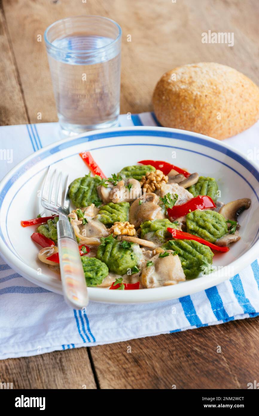 Spinach gnocchi with mushrooms and bell pepper Stock Photo Alamy