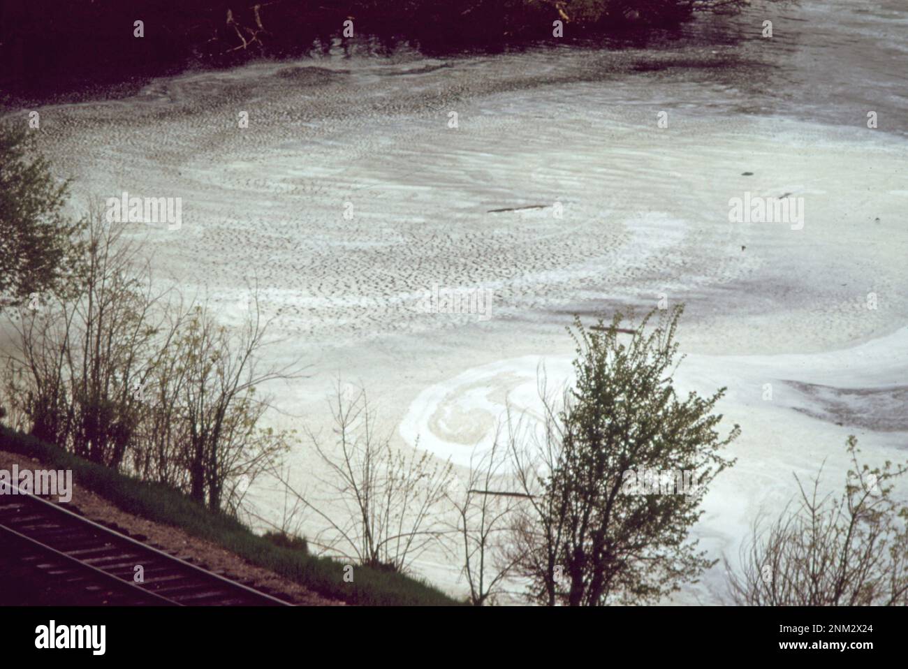 1970s United States: Foam, a sign of pollution, floats on the St. Croix ...