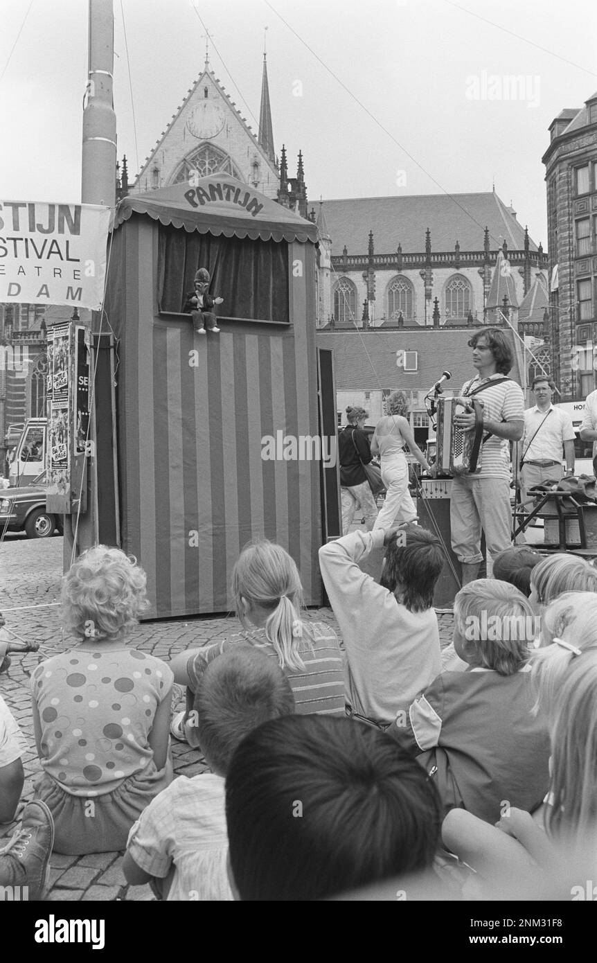 Children being entertained by a puppet theater on Dam Square in