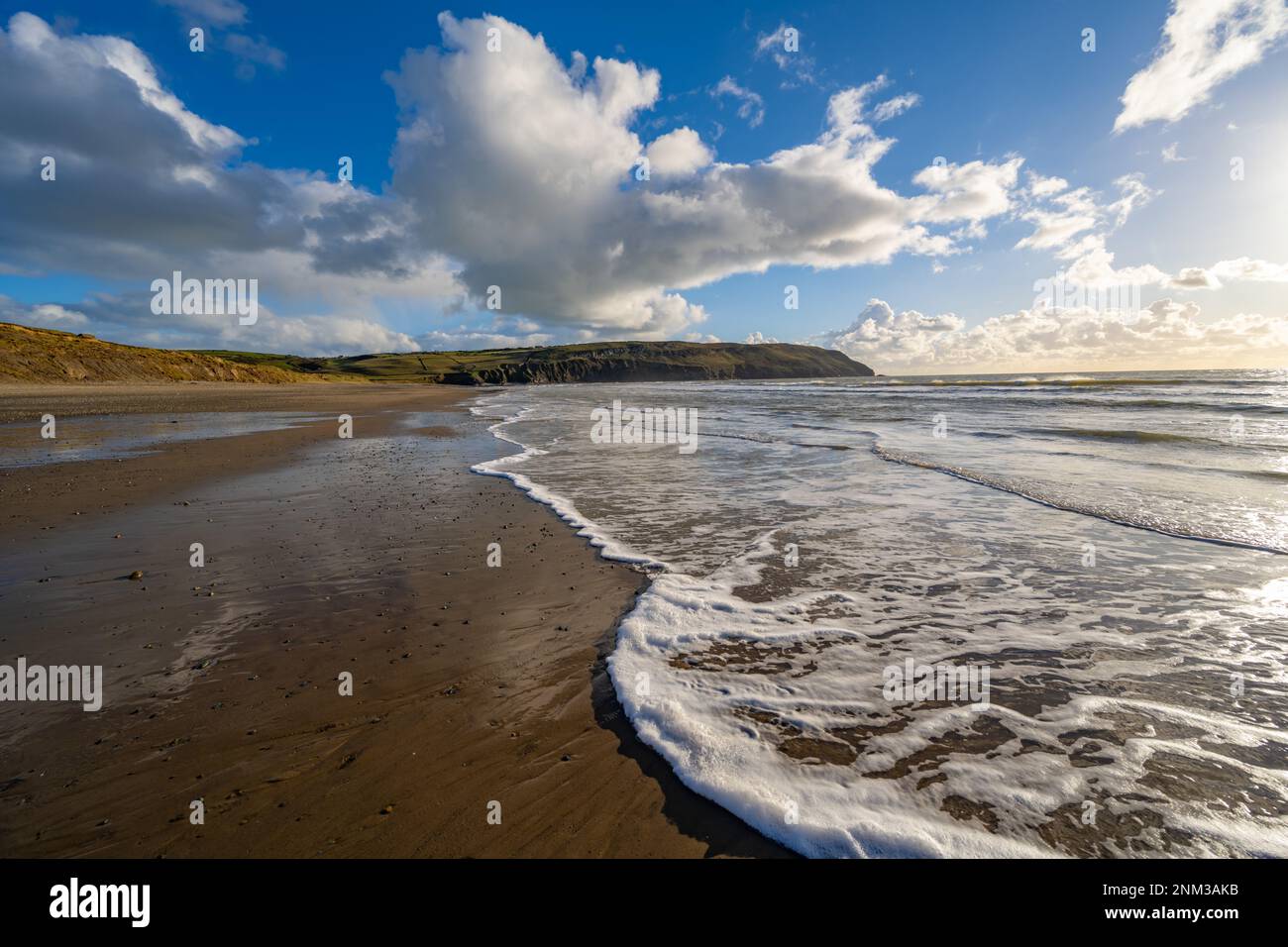 Waves breaking on the beach at Porth Neigwl bay also known as Hells mouth on the Llyn Peninsula near Llanengan North Wales. Stock Photo
