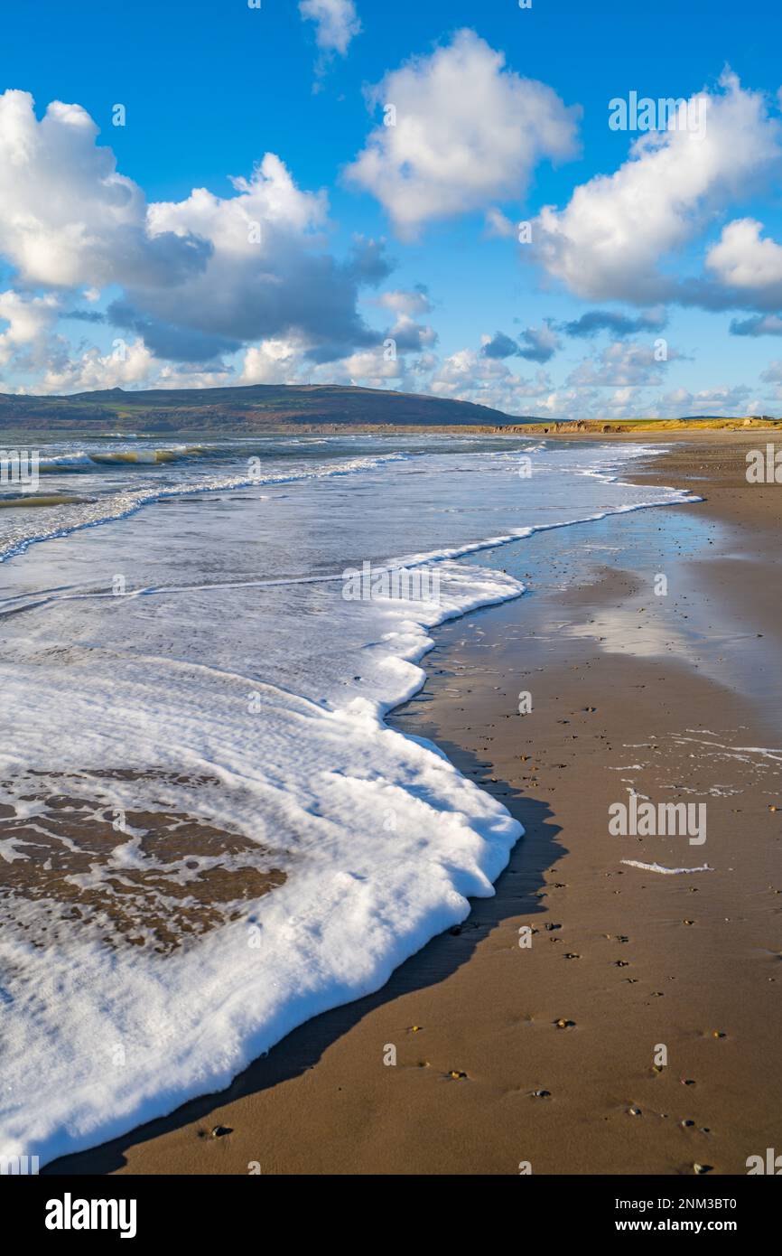 Waves breaking on the beach at Porth Neigwl bay also known as Hells mouth on the Llyn Peninsula near Llanengan North Wales. Stock Photo
