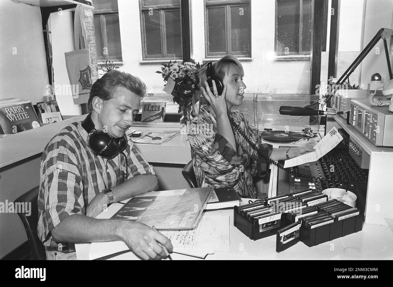 Ether pirate becomes legal youth radio WAPS; WAPS employee in their studio above the IJsbreker in Amsterdam (interior of a once pirate radio station) ca. 1985 Stock Photo