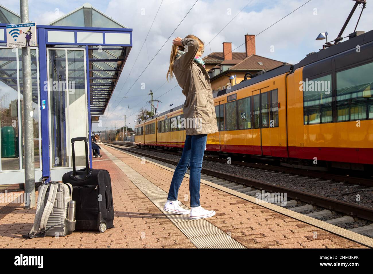 Young woman at the railway station in Weingarten, BadenWürttemberg