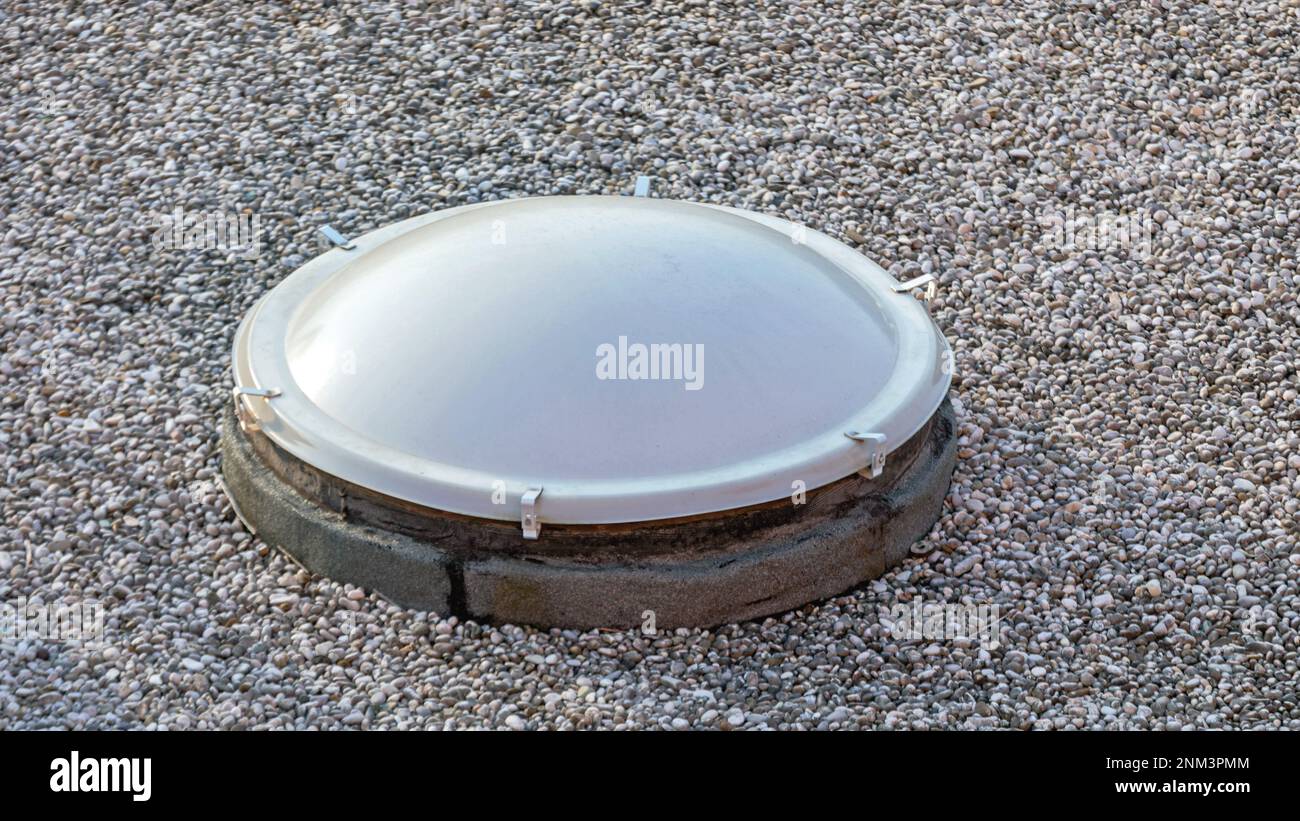 One Plastic Cover Skylight Dome Window at Gravel Industrial Roof Stock