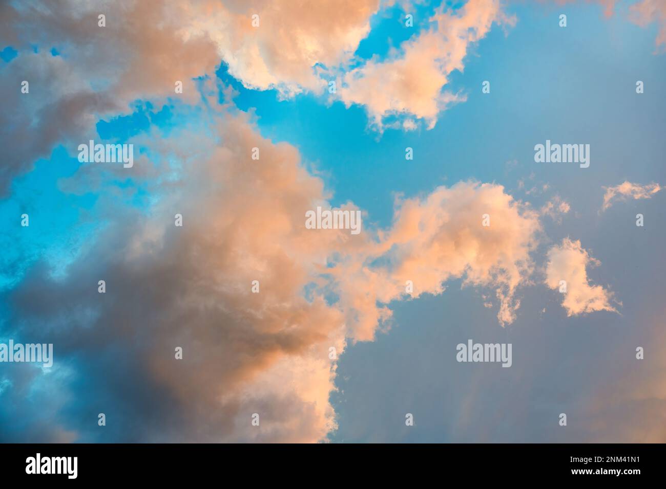 Beautiful dramatic orange clouds on blue sky in the evening Stock Photo