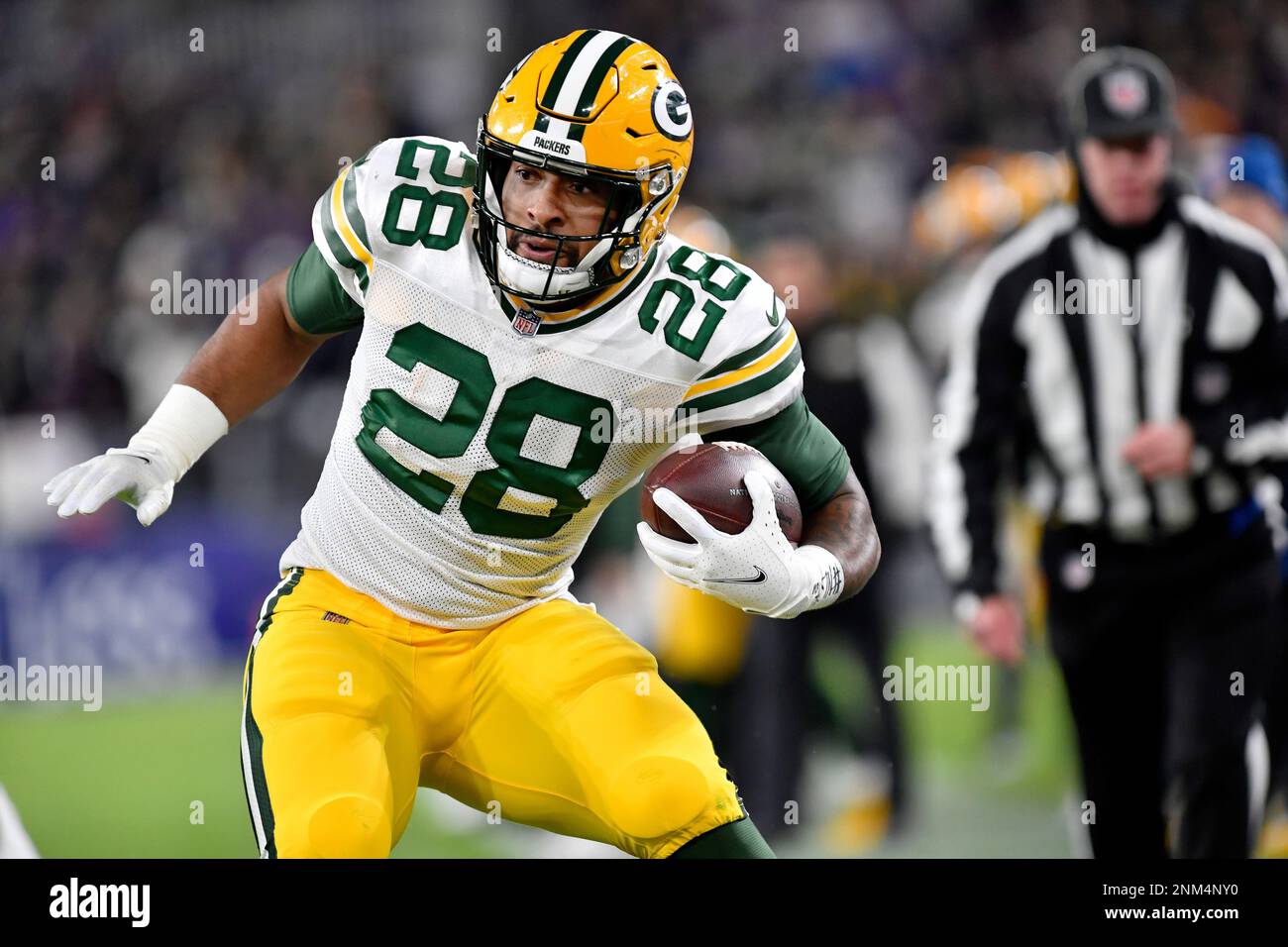 BALTIMORE, MD - DECEMBER 19: Packers running back A.J. Dillon (28) runs the  ball during the Green Bay Packers versus Baltimore Ravens NFL game at M&T  Bank Stadium on December 19, 2021