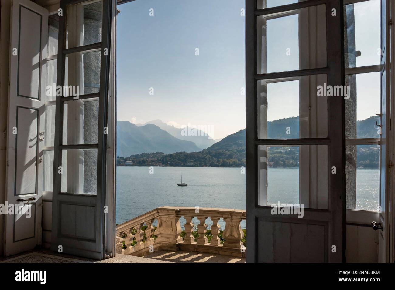 entrance to classical villa looking out over lake towards mountains on summers day Stock Photo