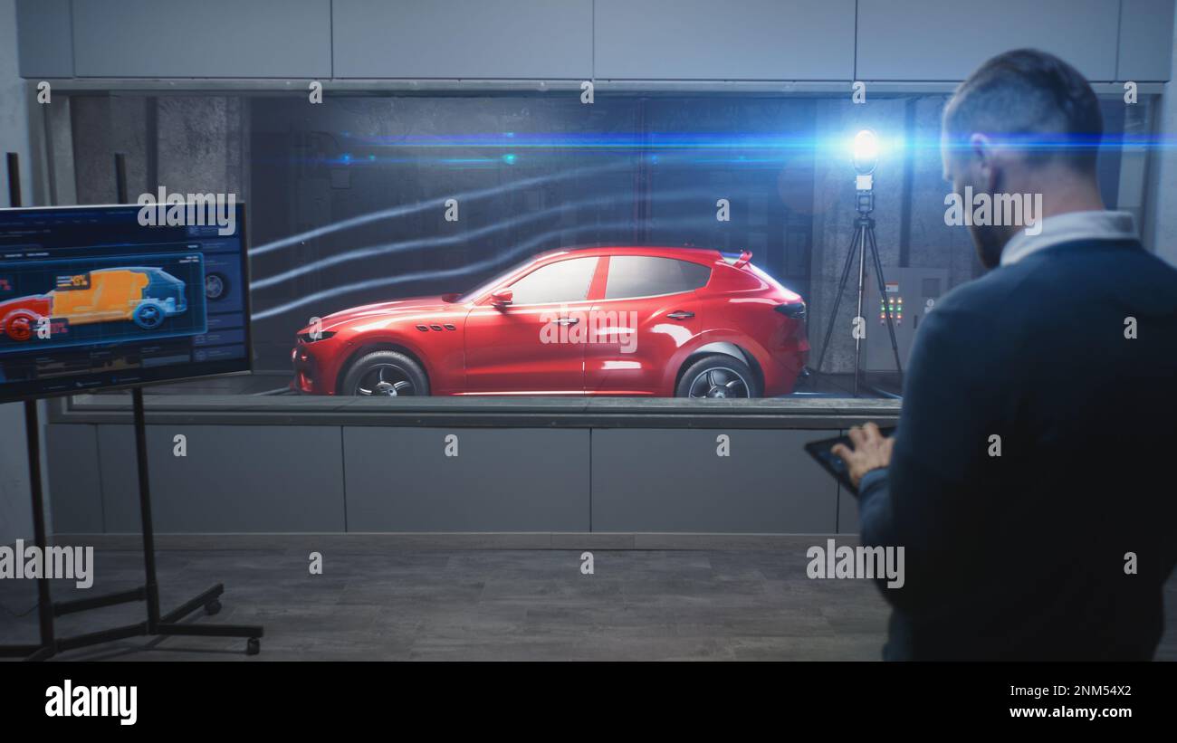 Testing aerodynamics of new generation eco-friendly electric car in lab using wind tunnel with steam. Digital tablet, LED screen with vehicle 3D model. Concept of car testing and modern technologies. Stock Photo