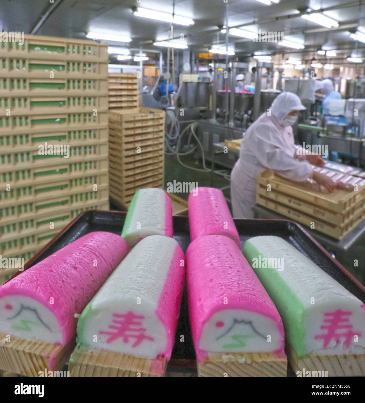 Workers make Kamaboko precessed fish paste for Osechi, Japanese