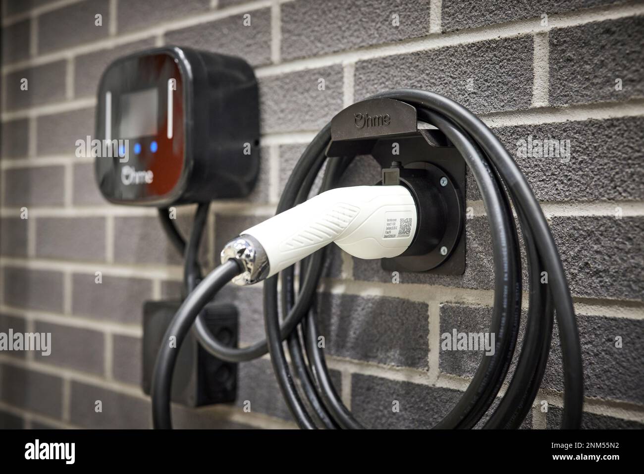 Electric car charger on the side of a modern UK home Stock Photo