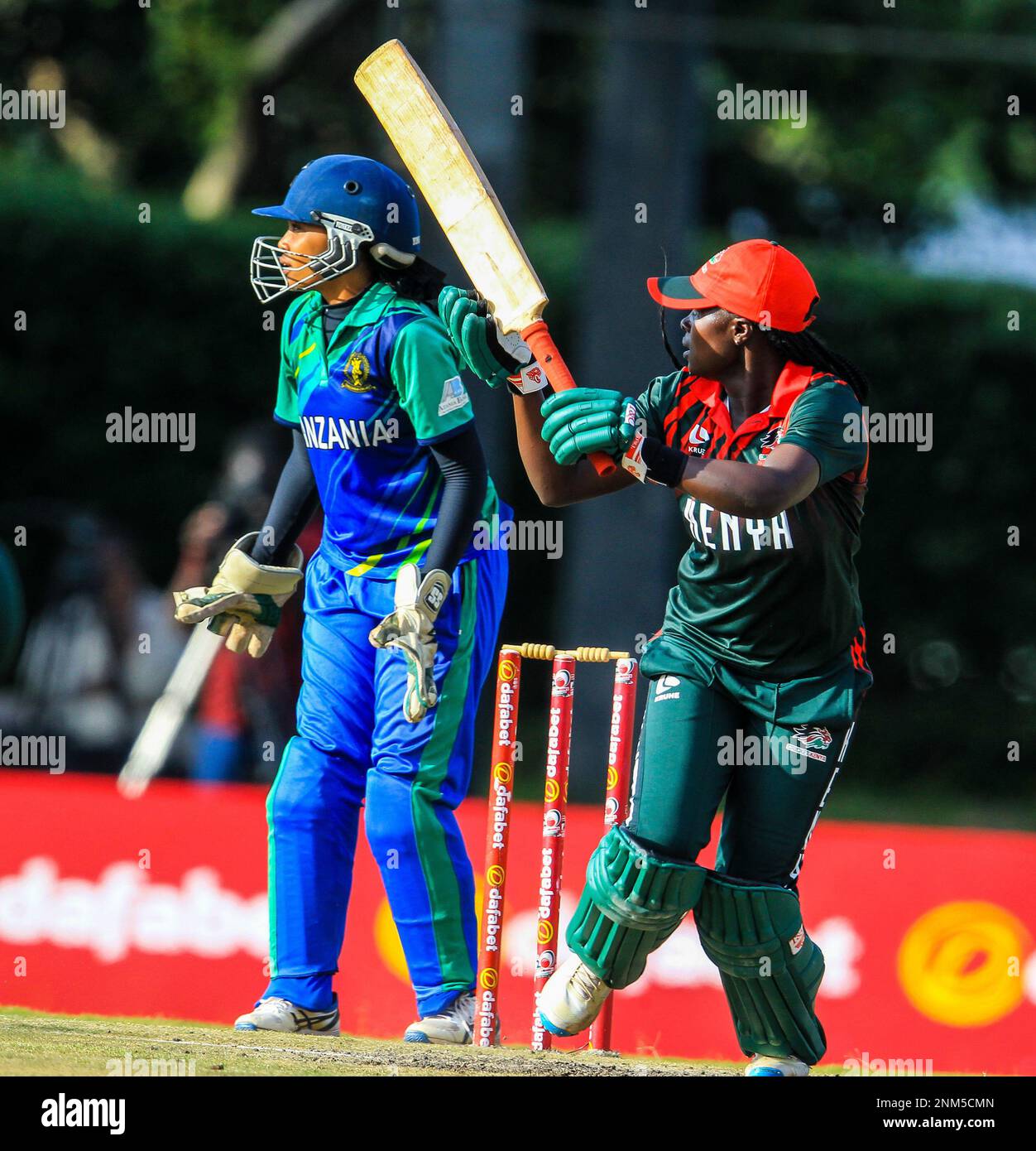 Kenya batter Veronica Abuga batting, with Tanzania Wicketkeeper Shufaa ...