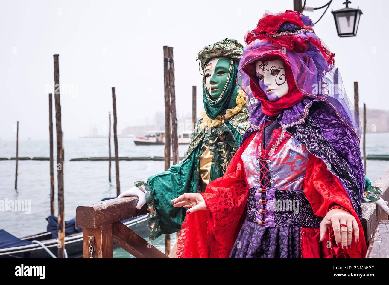 Portrait of a couple of carnival masks in Venice at the pier Stock ...