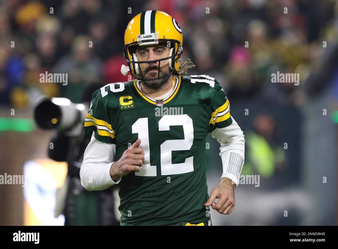 Green Bay Packers quarterback Aaron Rodgers (12) runs onto the