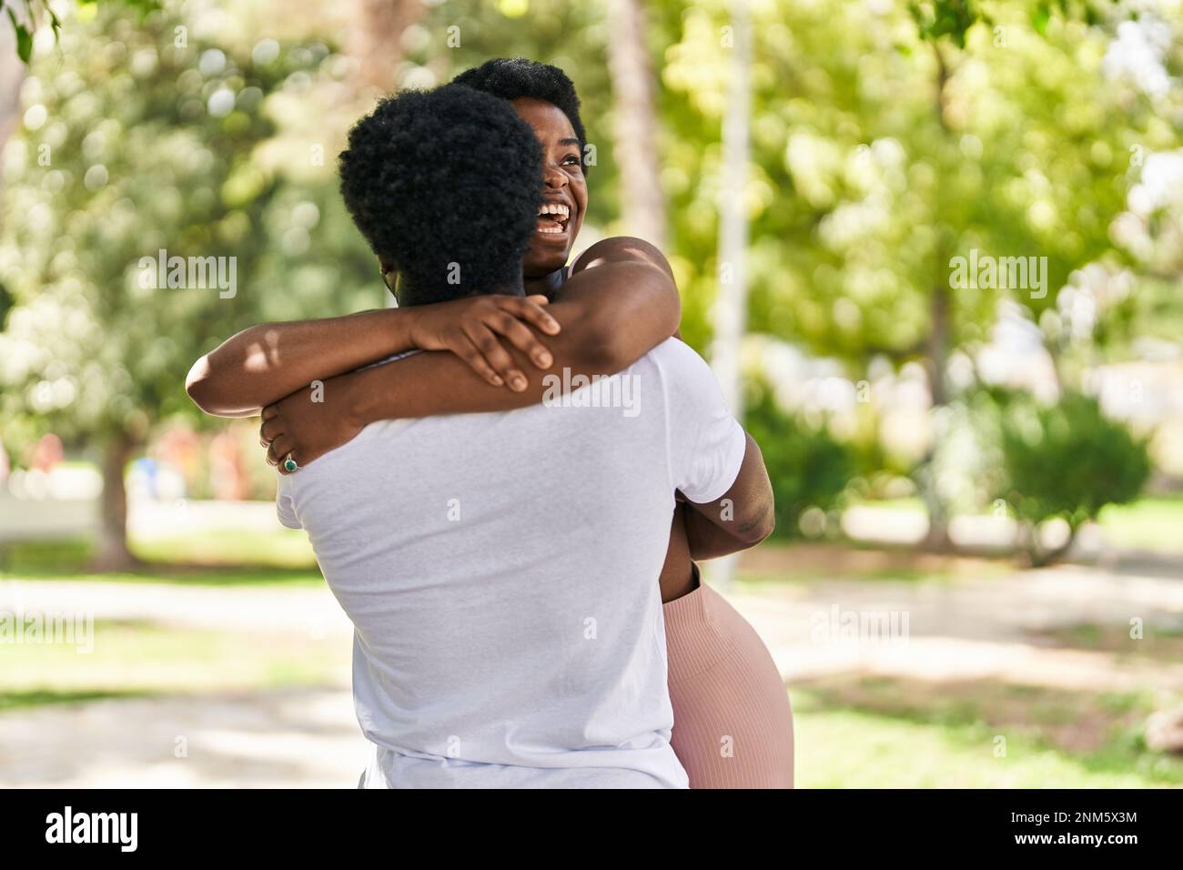 African american man and woman couple smiling confident hugging each ...