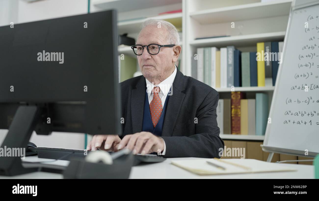 senior university teacher using computer at university classroom Stock ...