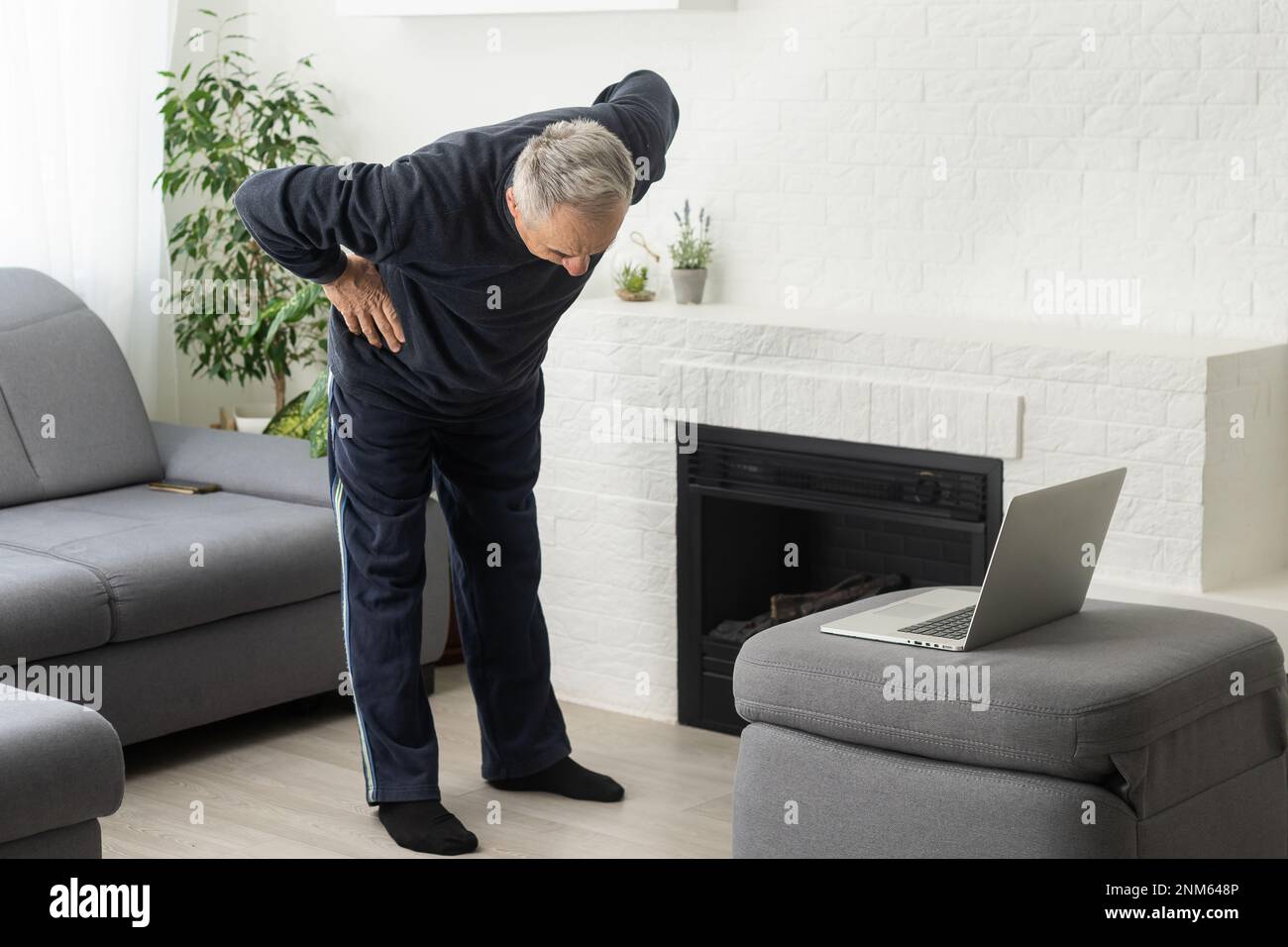 Sport in mature age. Happy middle-aged man doing stretching exercises ...