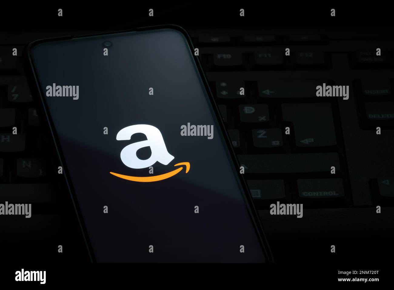 Ljubljana, Slovenia - 21 January 2023: Amazon logo on smartphone screen laying on computer keyboard Stock Photo