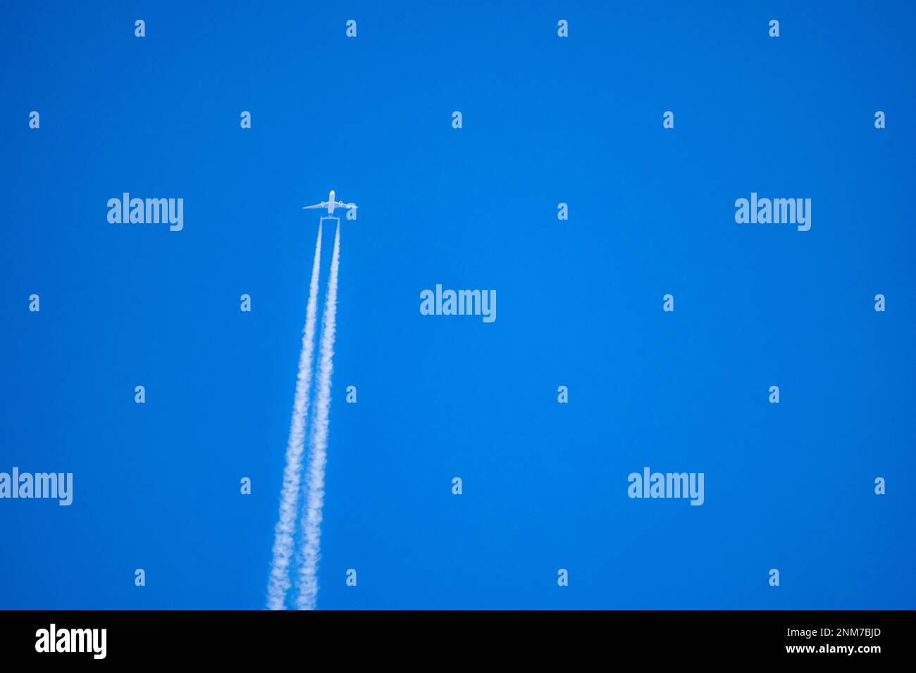 Vapor trails in thy sky from a jumbo jet at high altitude Stock Photo