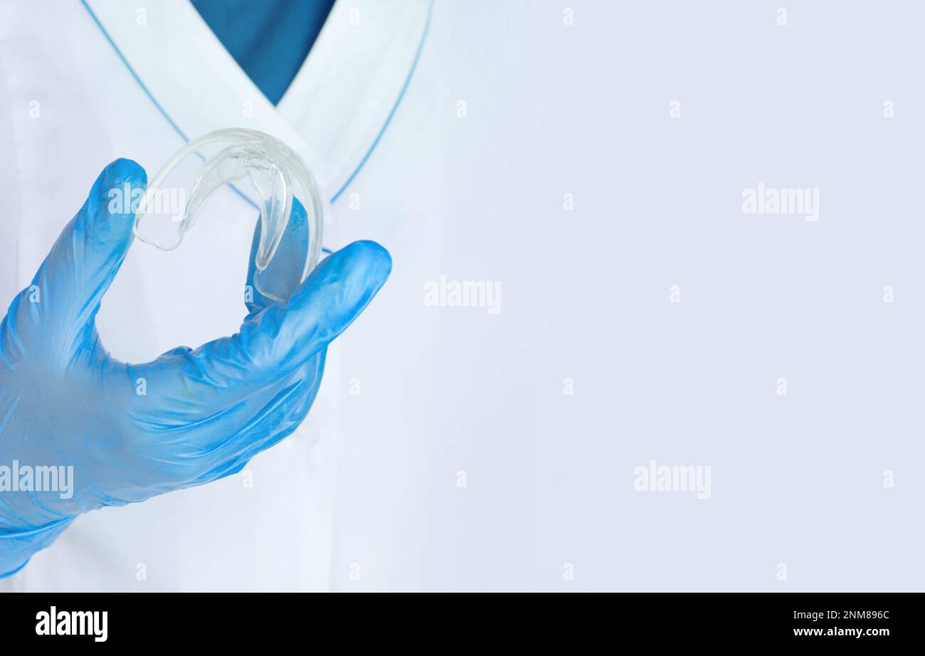 Teeth Whitening Tooth Tray in doctors hand, Closeup. Invisible