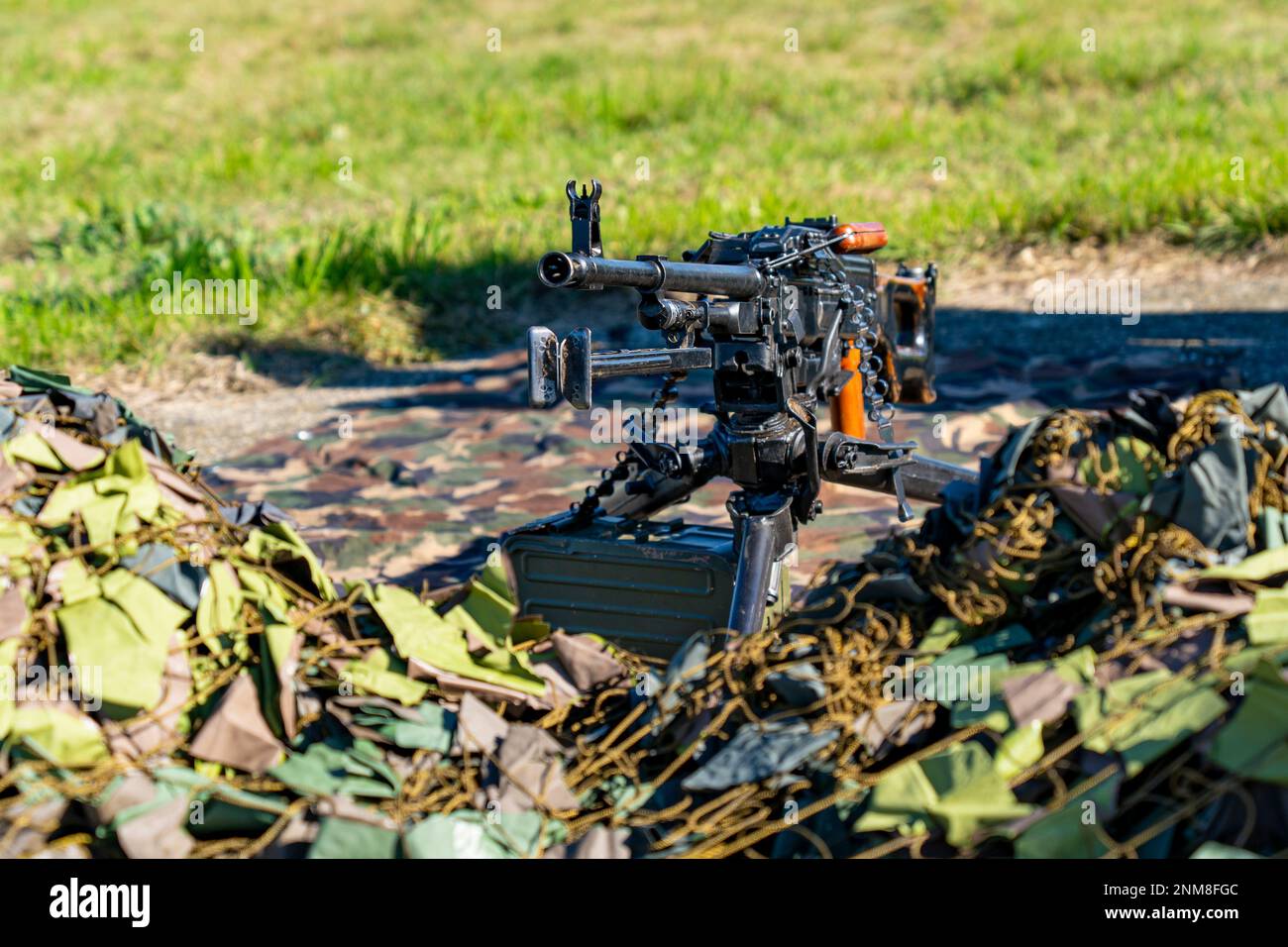 Soviet-made PK machine gun and camouflage netting.. 'Kalashnikov's machine gun' Stock Photo