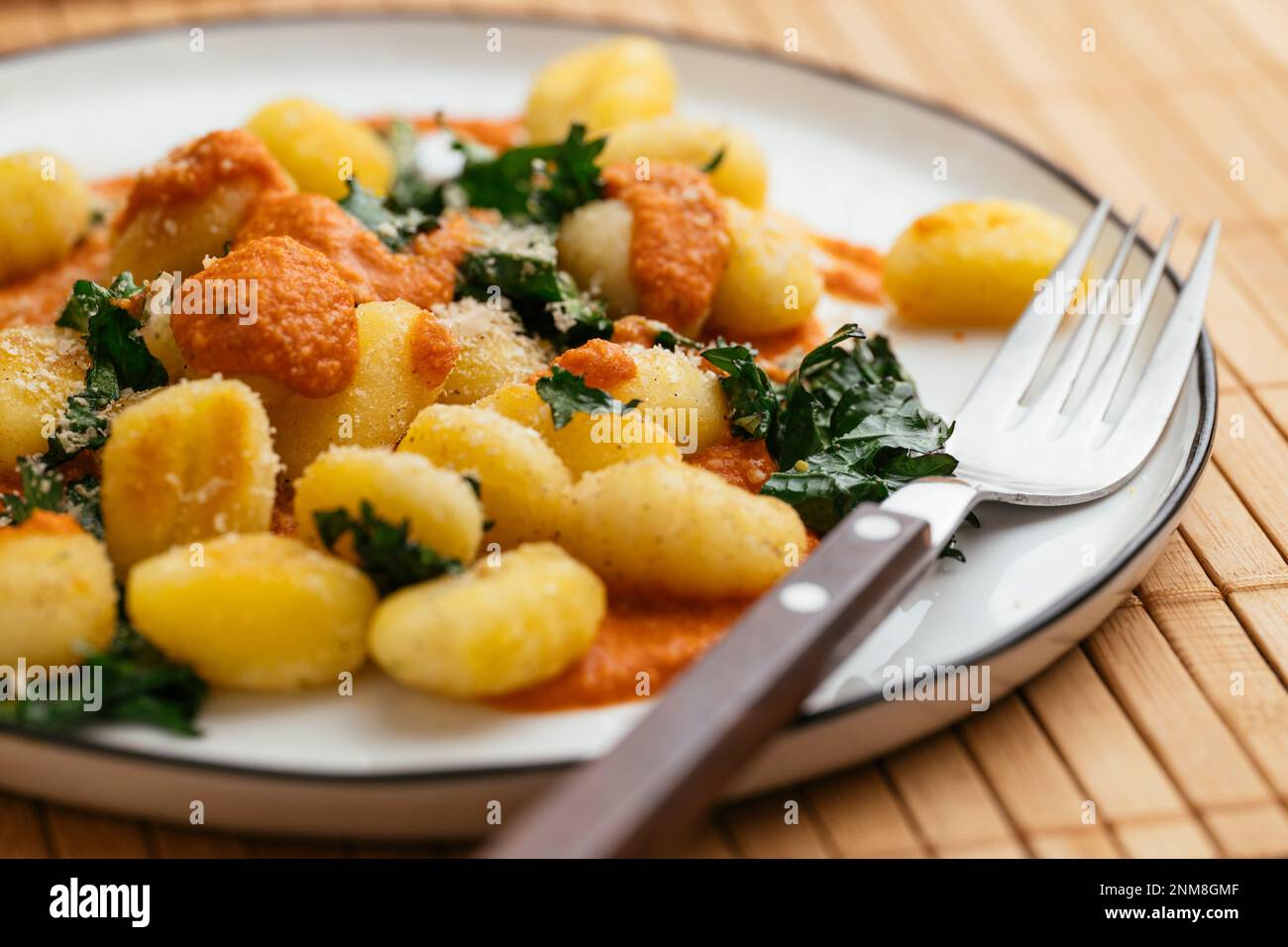 Gnocchi with Kale and Roasted Paprika Sauce Stock Photo - Alamy