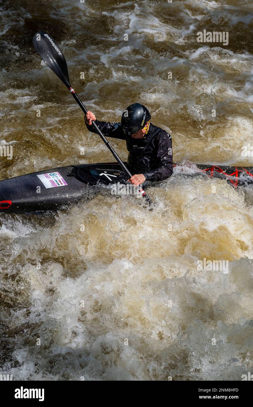 A man kayaking on the Tryweryn river, National White Water Centre, canoeing watersports, near Bala, Wales Stock Photo