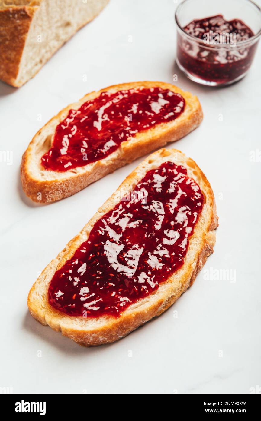 Raspberry jam on toast Stock Photo Alamy