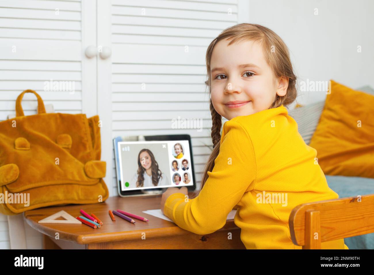 Smart child girl student studying with laptop at home Stock Photo - Alamy