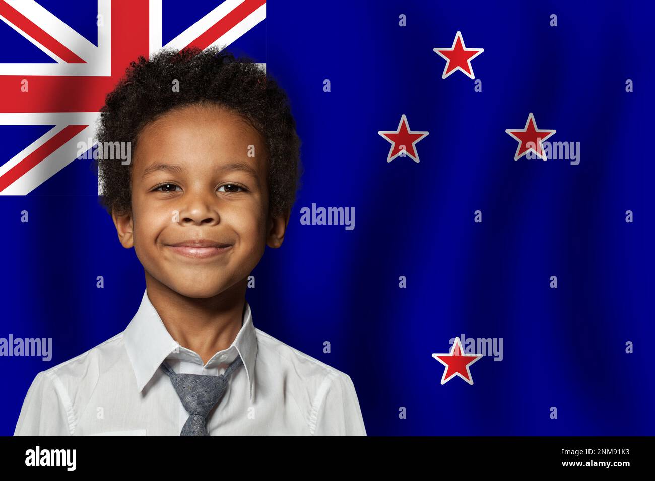New Zealand kid boy on flag of New Zealand background. Education and