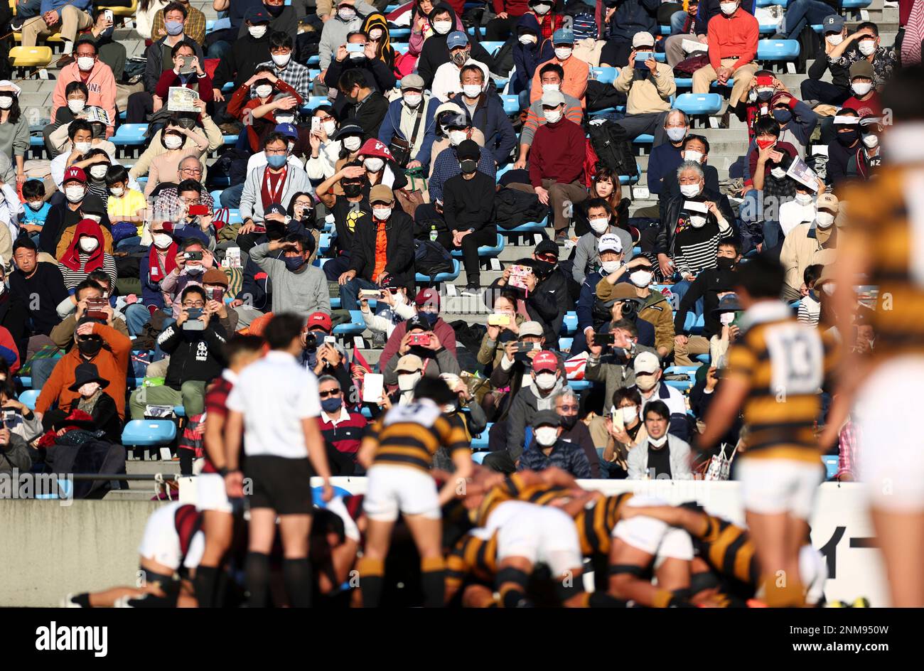 Spectator Watching Rugby Match Spectators wearing masks enjoy watching a rugby match between Waseda ...
