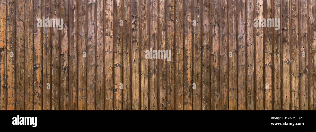 Weathered wood paneling made of vertical brown boards Stock Photo