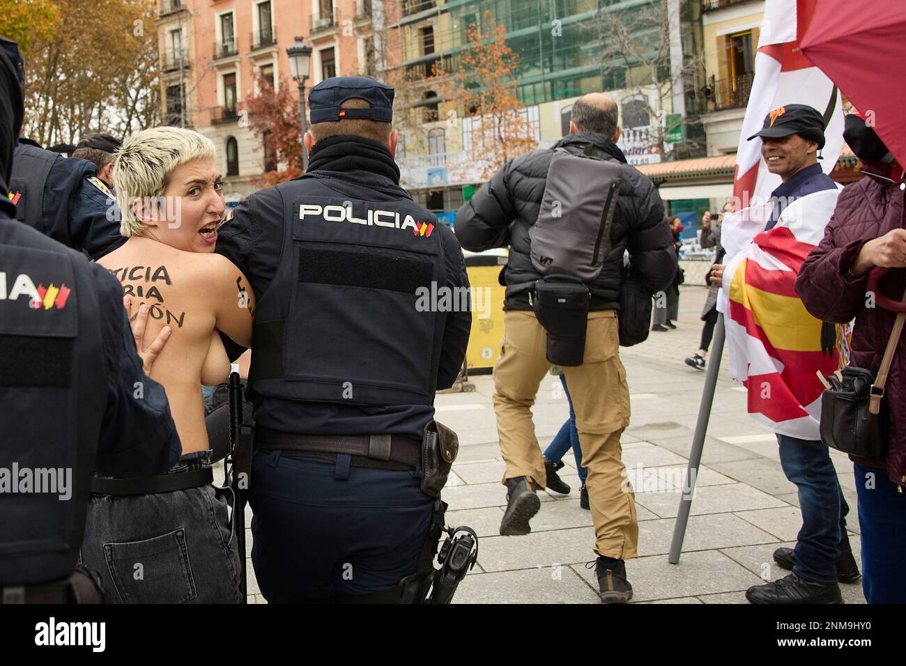 National police officers hold a female activist protesting in front of ...