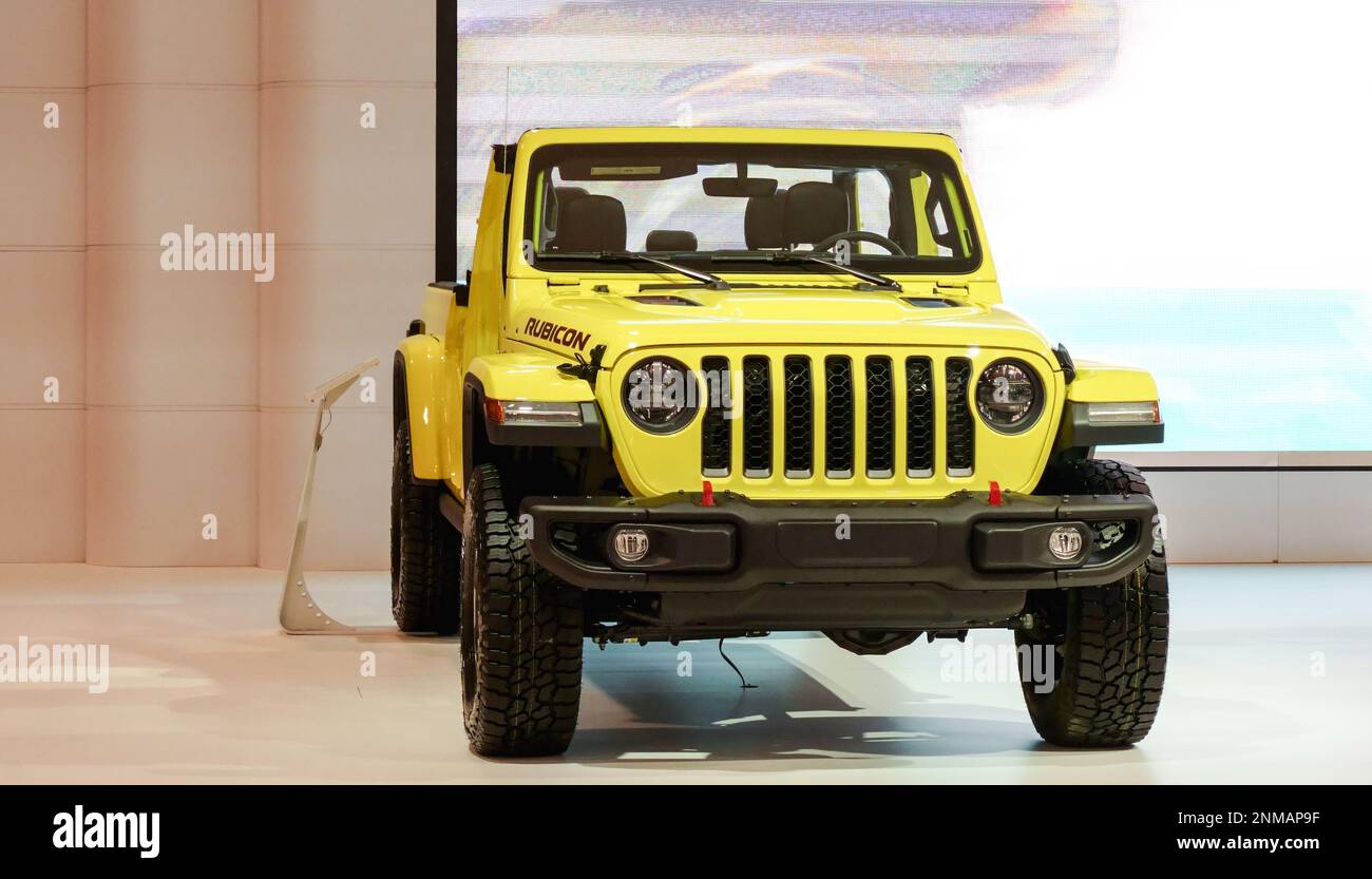 Yellow Rubicon Jeep car on display.Crowds looking at new car models at Auto show. National Canadian Auto Show with many car brands. Toronto ON Canada Stock Photo