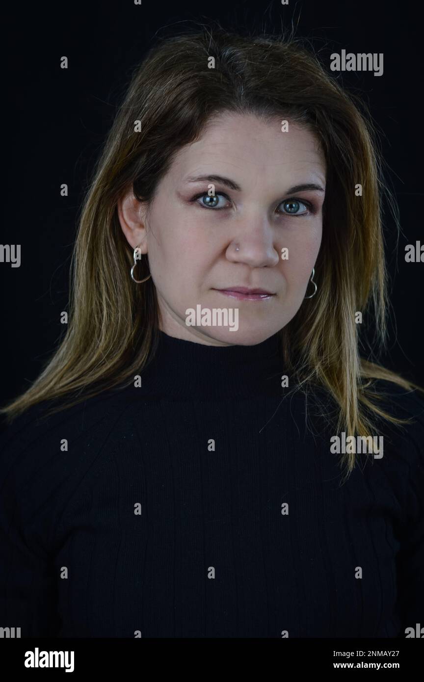 portrait of a beautiful blonde woman with a serious and severe look