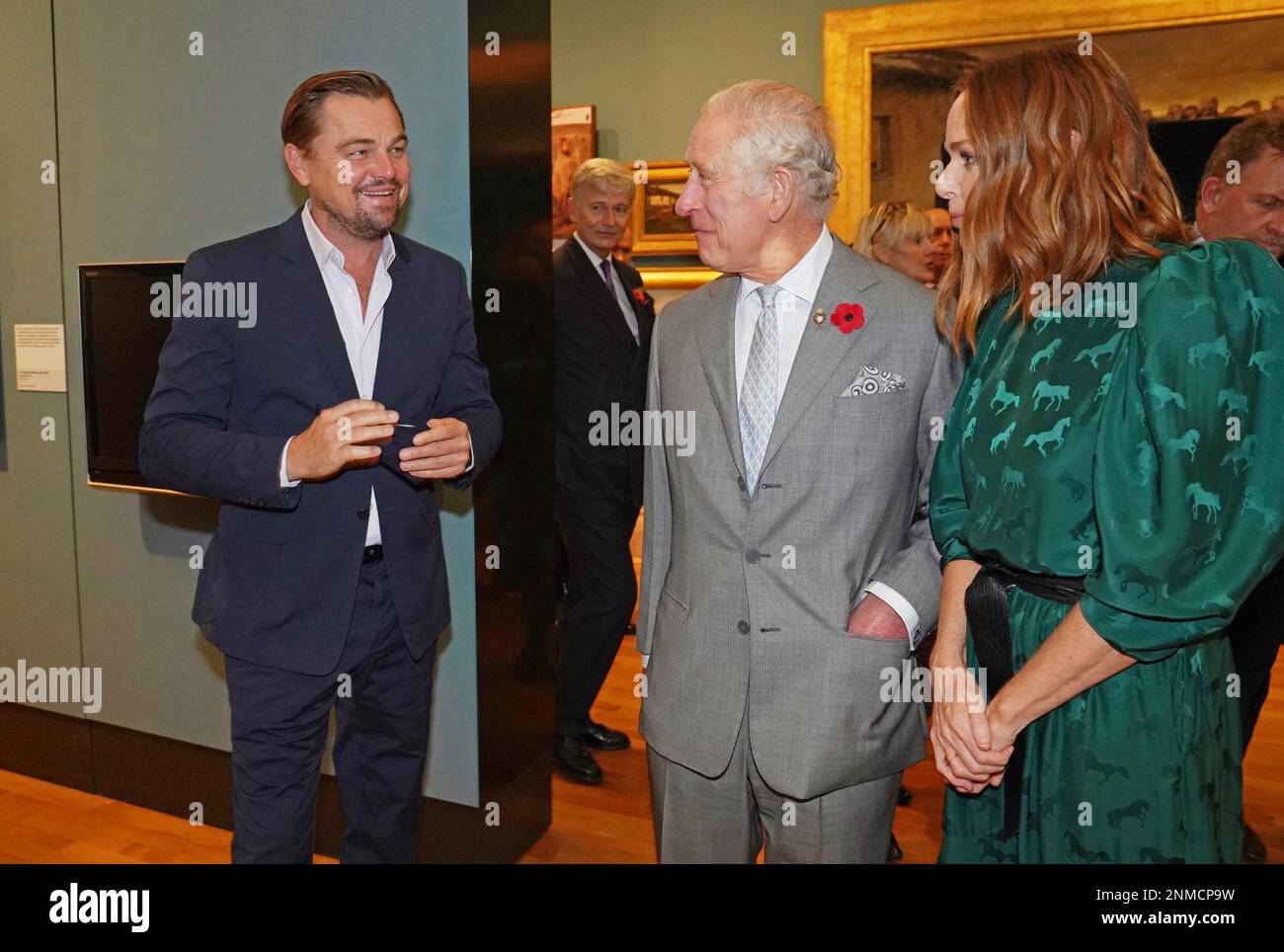 Britain's Prince Charles, center, speaks with designer Stella McCartney