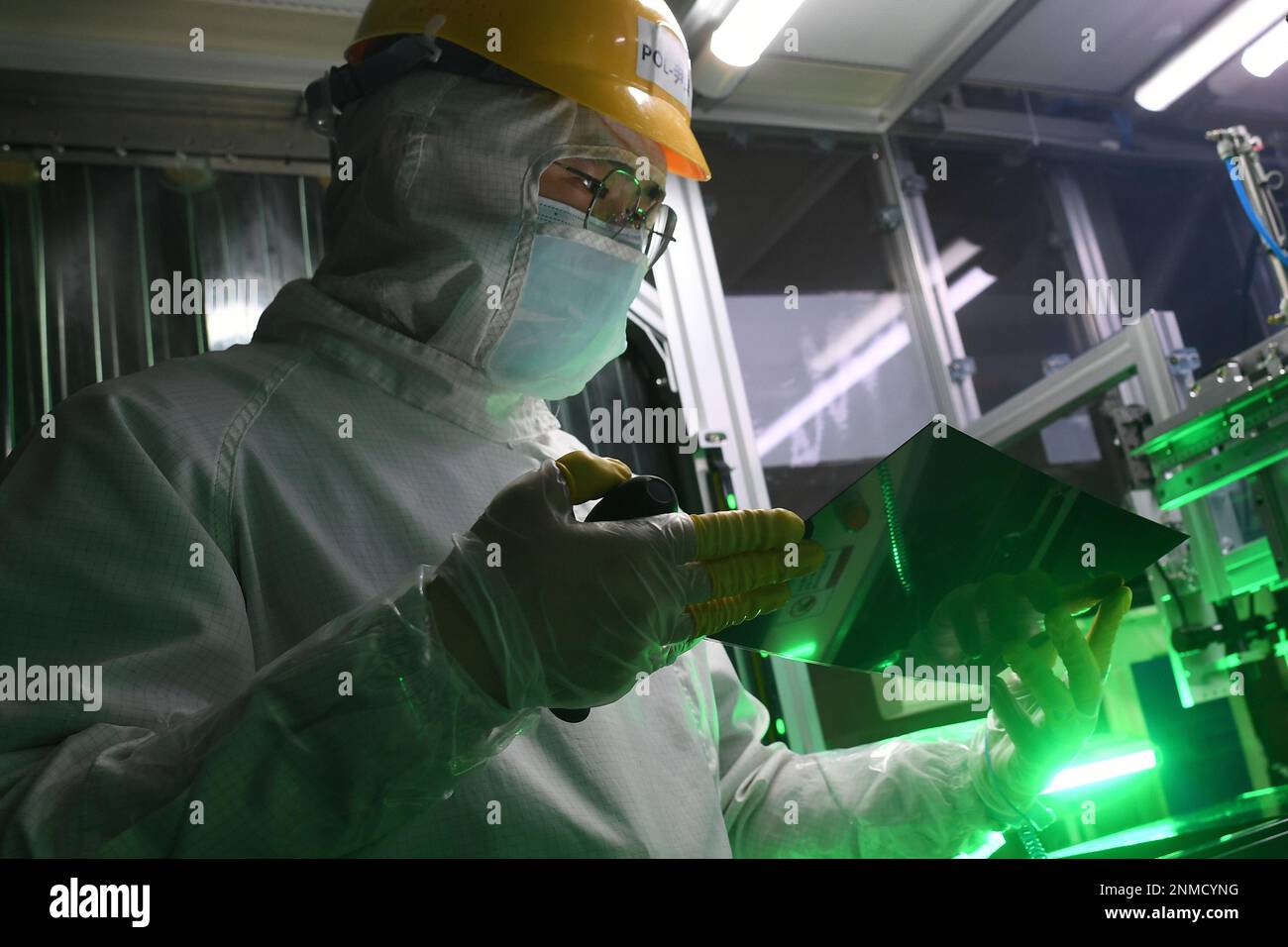 An employee works in a cleanroom of the production of LTPS (LowTemperature Polysilicon