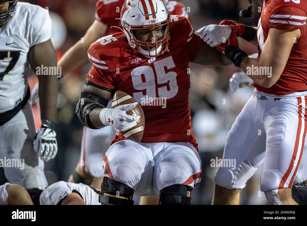 Wisconsin Badgers defensive lineman Keeanu Benton (95) celebrates a