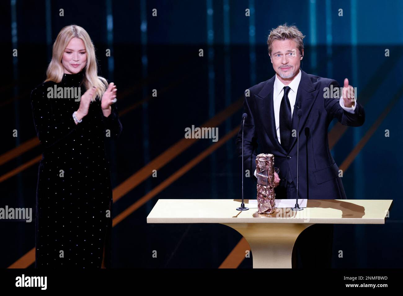 Actor Brad Pitt reacts next to actress Virginie Efira during the 48th