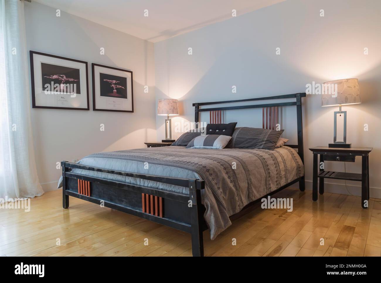 Black cherry wood frame queen size bed with charcoal grey bedspread in main bedroom inside