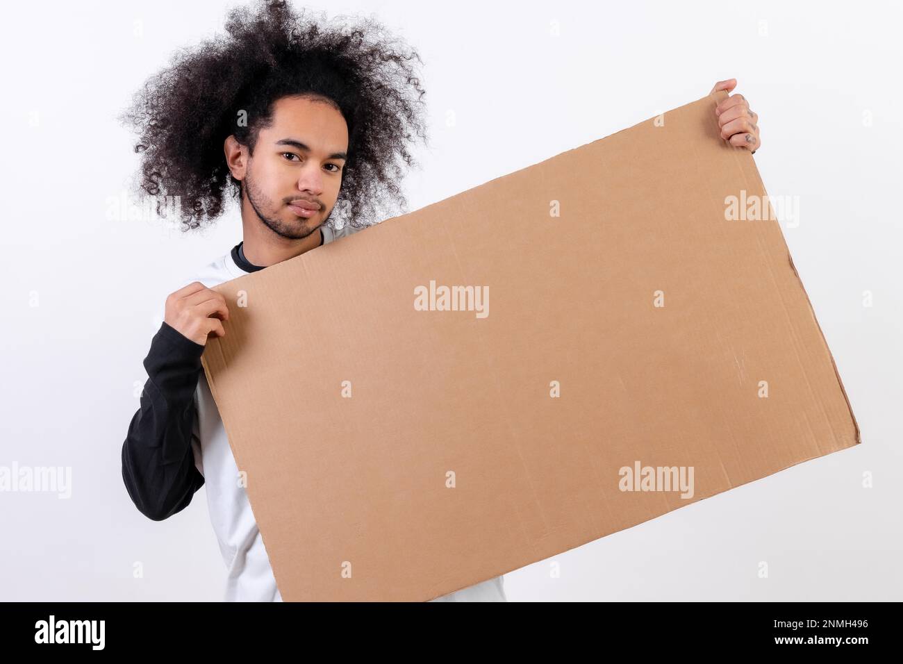 Holding a sign with copy paste space. Young man with afro hair on white ...