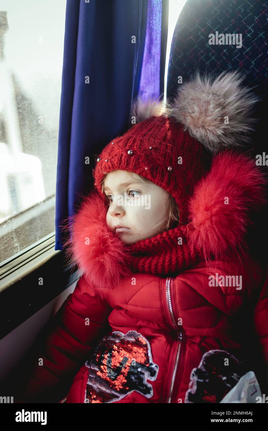Polina, 4 years old, fleeing with her mother and grandmother from Perejaslaw, on the bus from Medyka to Przemysl, they want to continue, first to Stock Photo