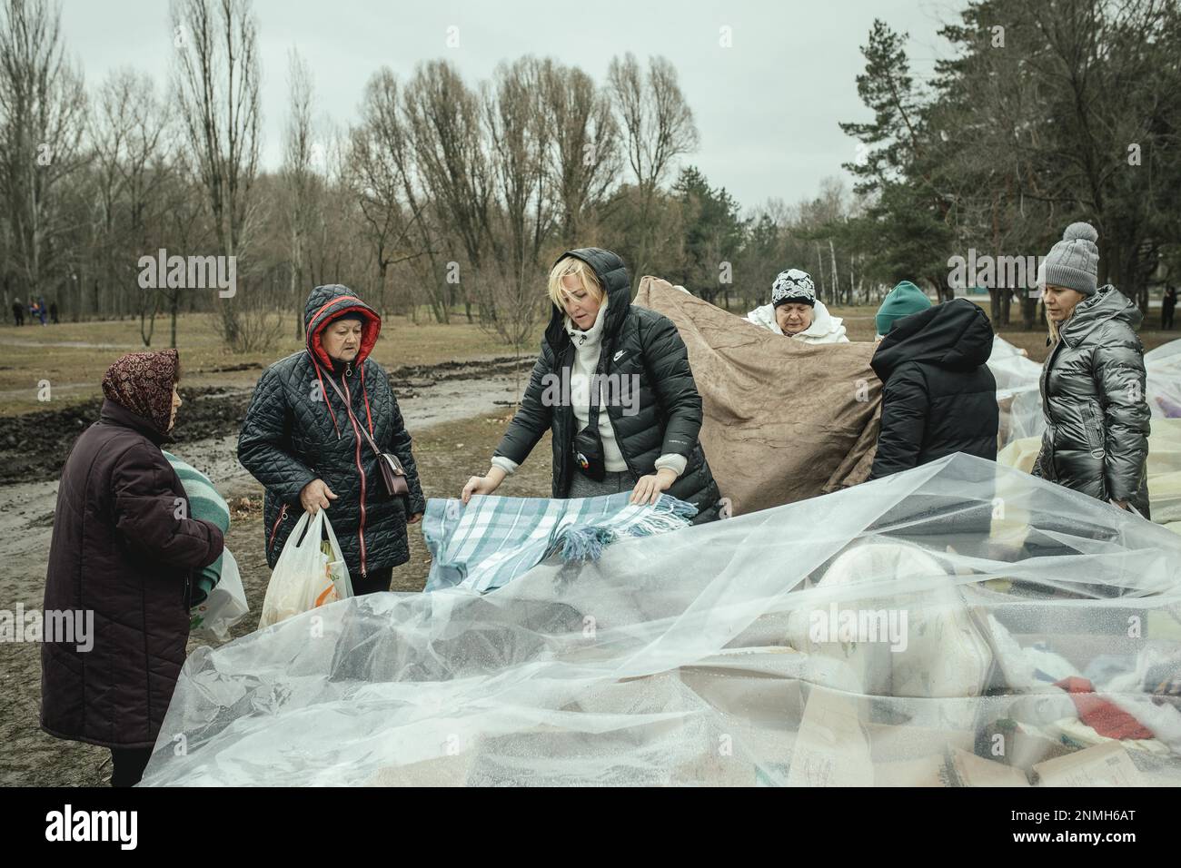 Residents of the house destroyed by a Russian missile attack that killed 45 people receive relief goods from neighbourhood donations, Dnipro Stock Photo