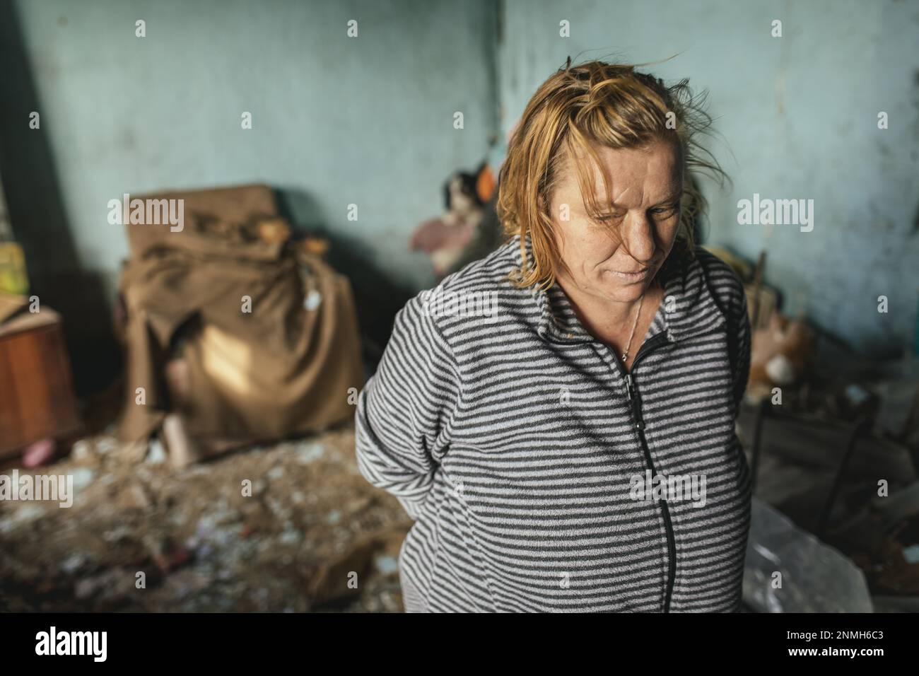 Nadja, 41 years old, in the ruins of her familys house, the familys house in Possad-Pogrovske was completely destroyed by a Russian missile attack Stock Photo