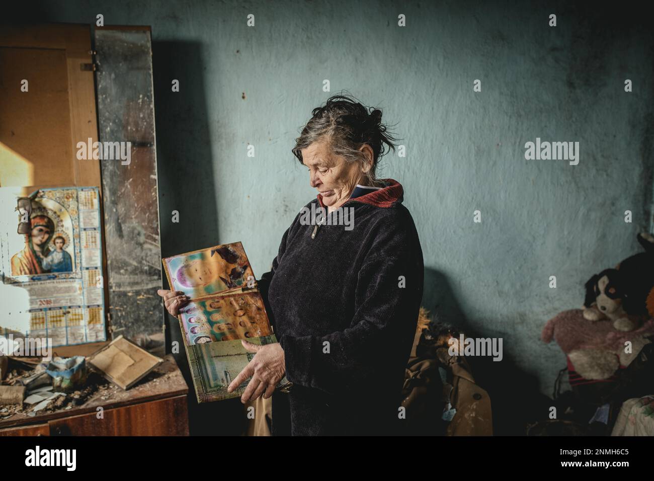 Tatjana, 60, in the ruins of the house she had lived in with her family in front of it was destroyed in a Russian missile attack, her man Viktor and Stock Photo