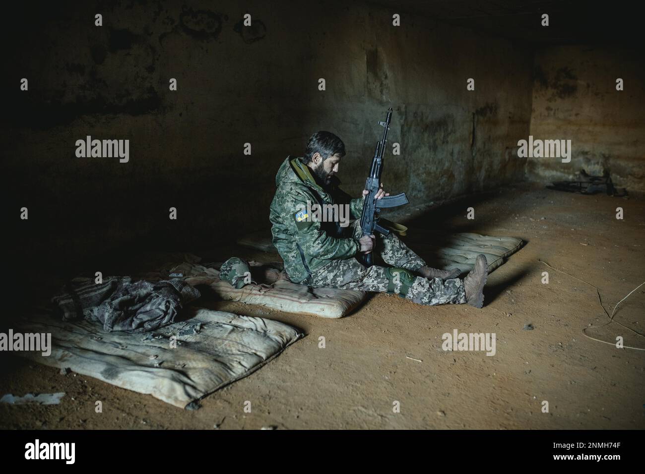 Soldier on his sleeping pad in his units accommodation, he was one of the 14 defenders who managed to defend the small town against a Russian Stock Photo