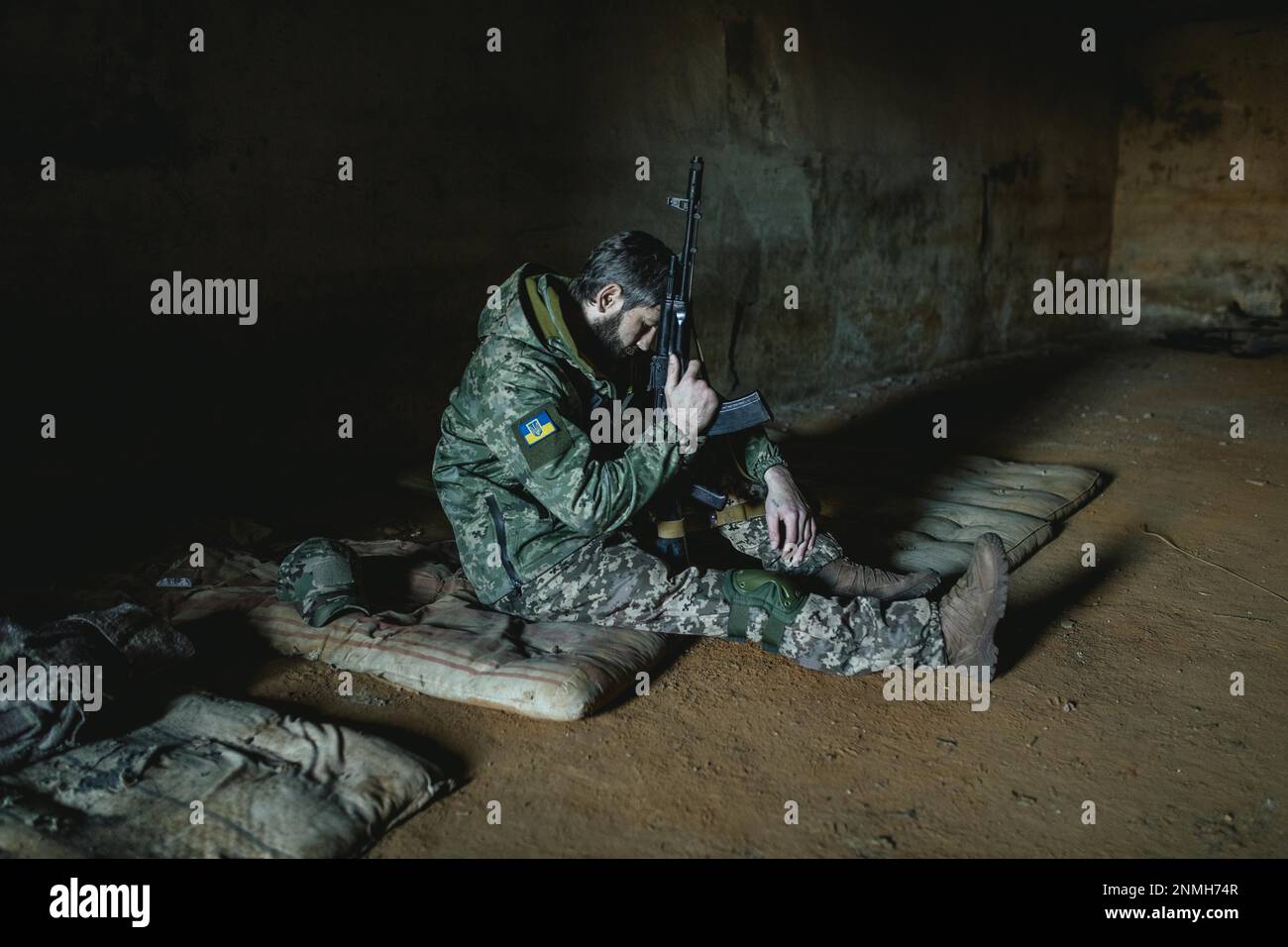 Soldier on his sleeping pad in his units accommodation, he was one of the 14 defenders who managed to defend the small town against a Russian Stock Photo