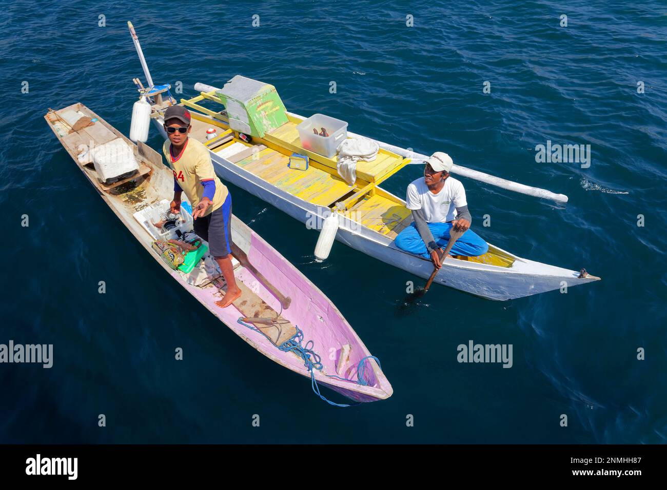 Two men, Indonesian, young, with boat on sea, colourful, offering souvenirs, handicraft, handicrafts, Komodo National Park, Unesco World Heritage Stock Photo